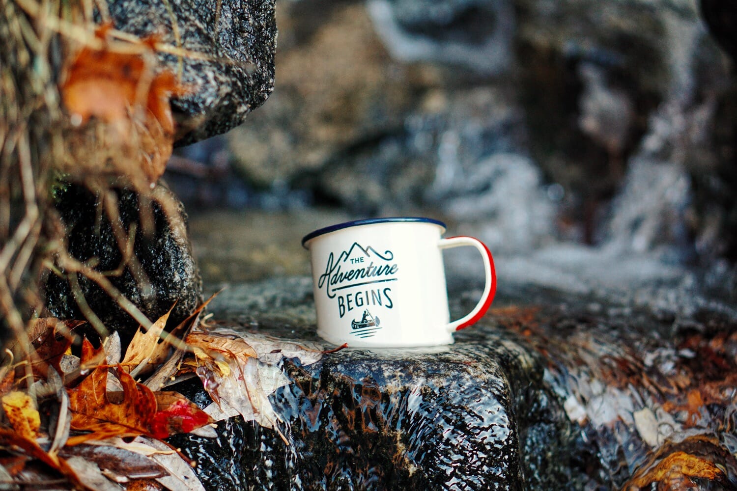 outdoor adventure mug on rocks