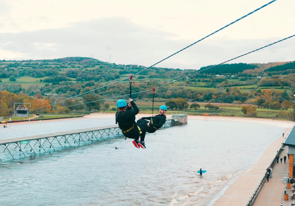 Zip-lining over surf lagoon in Snowdonia Zip-lining over surf lagoon in Snowdonia