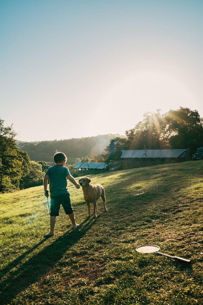 Exe Valley Glamping, Devon, boy and dog playing