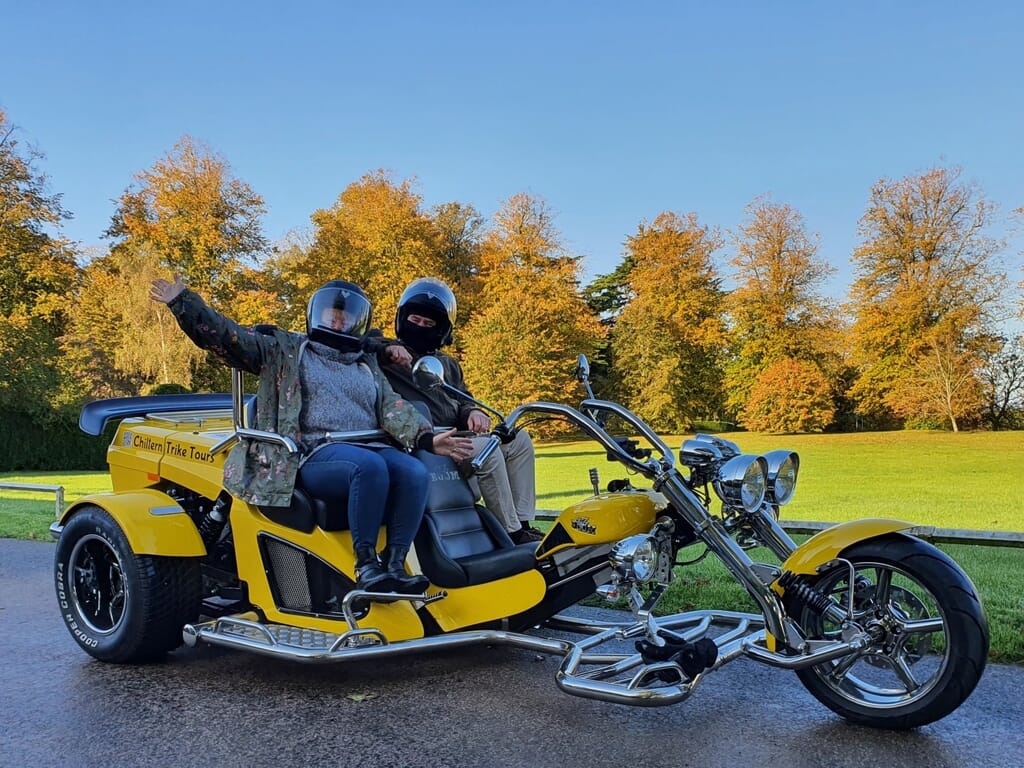 Couple aboard Chiltern Trike Tours with autumn trees