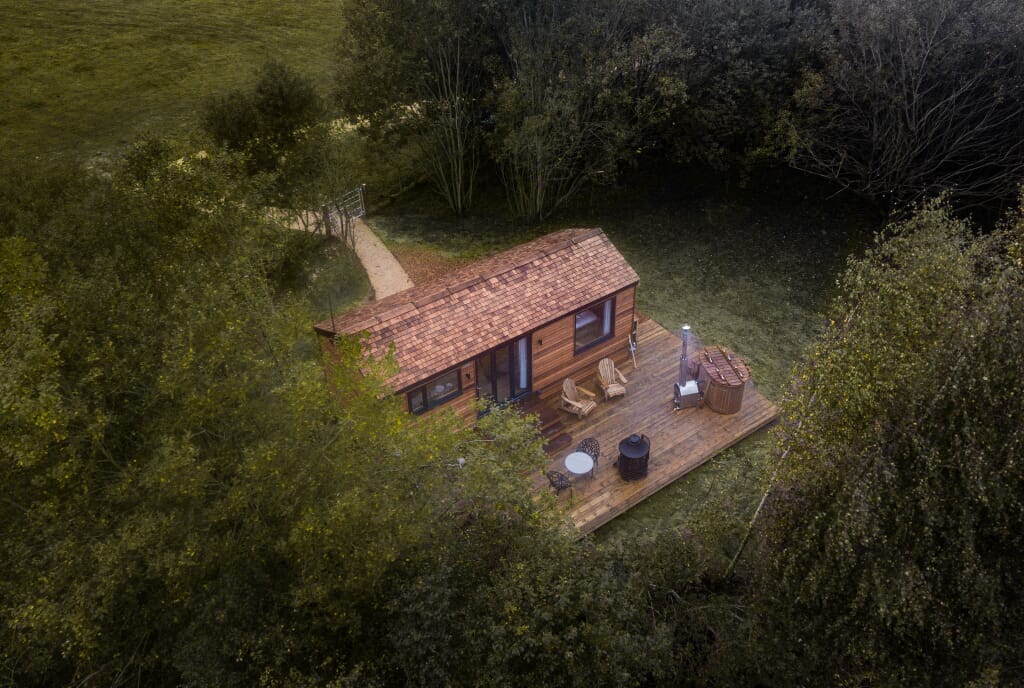 log cabin in woods sussex: coddiwomple from air