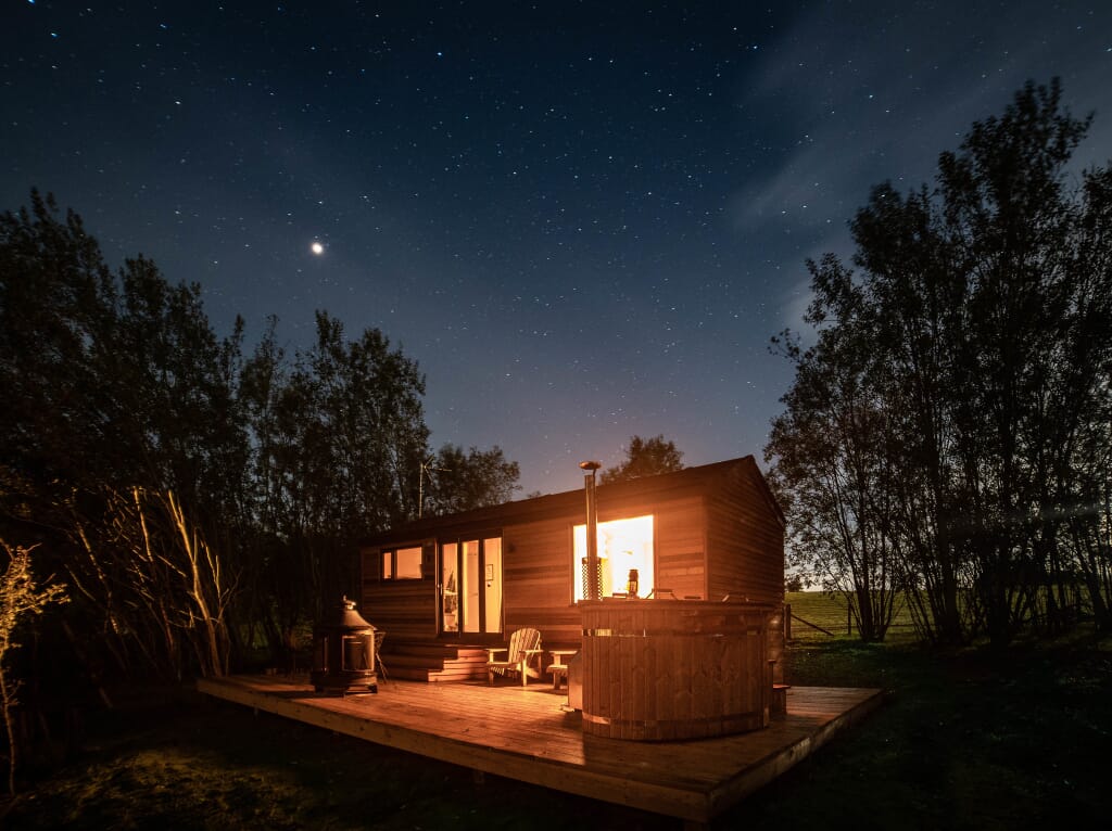 log cabin in woods sussex: coddiwomple at night