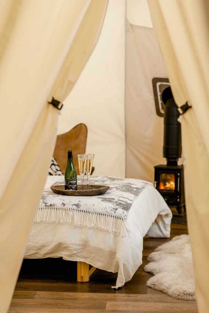 harta-retreat-luxury-glamping-woolacombe:: tipi bed and log burner