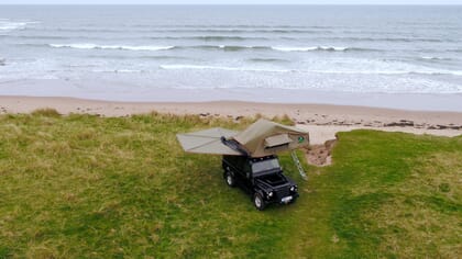 landrover defender camping tent set-up on beach