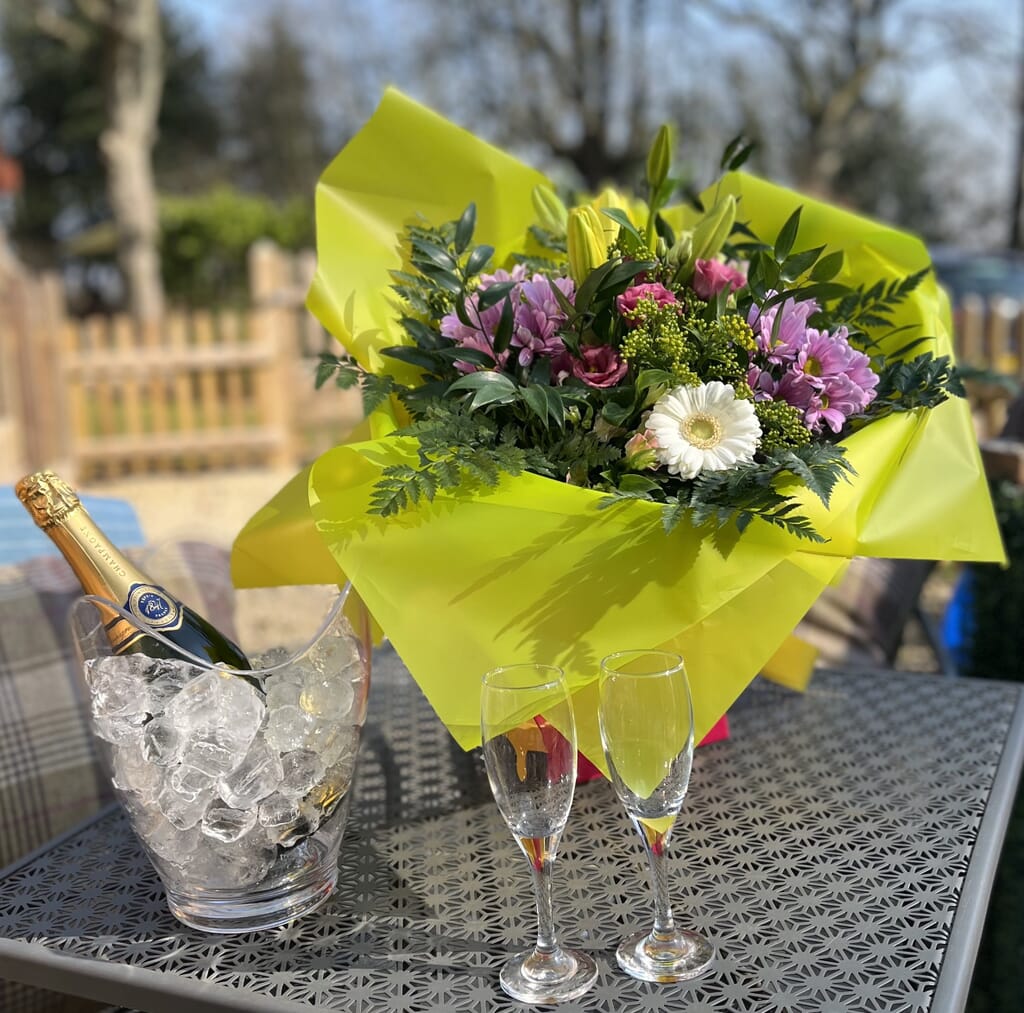 Mallory-meadows-glamping-leicestershire - flowers and chanpagne